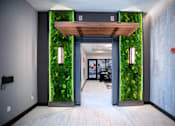 Thumbnail 28 of 31 - a lobby with a green wall with moss on it