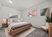 Thumbnail 7 of 26 - A bedroom with a large bed and a painting on the wall.