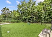 Thumbnail 79 of 87 - A backyard with a green lawn and a fence.