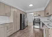 Thumbnail 5 of 47 - a kitchen with wooden cabinets and stainless steel appliances at Edge At Farmington Hills - Farmington Hills, MI, Michigan, 48334