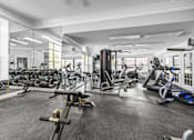 Thumbnail 72 of 87 - Fitness center with cardio and weight equipment at Village Club of Farmington Hills Apartments, Farmington Hills, Michigan