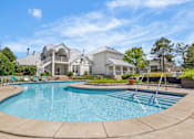 Thumbnail 65 of 87 - Resort style swimming pool with clubhouse views at Village Club of Farmington Hills Apartments, Michigan