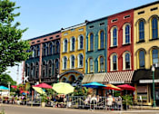 Thumbnail 36 of 39 - A row of colorful buildings with a street in front.