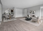 Thumbnail 16 of 33 - A modern living room with a dining table and chairs.