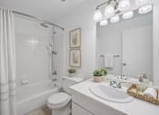 Thumbnail 9 of 26 - A white bathroom with a toilet, sink, and shower.