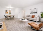 Thumbnail 6 of 29 - A living room with a grey carpet and a white couch.