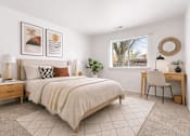 Thumbnail 9 of 29 - A bedroom with a large bed, a desk, and a chair.