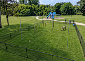 Thumbnail 30 of 35 - A playground with a blue slide and a green lawn.