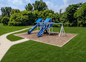 Thumbnail 29 of 35 - A blue and white playground slide in a park.