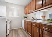 Thumbnail 16 of 35 - A kitchen with wooden cabinets and a white refrigerator.