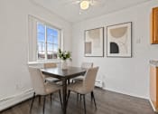 Thumbnail 7 of 23 - A dining room with a table and chairs.
