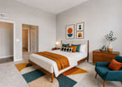 Thumbnail 24 of 58 - A bedroom with a bed, a chair, and a plant.