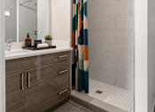 Thumbnail 26 of 58 - A bathroom with a shower curtain and a sink.