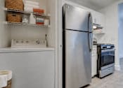 Thumbnail 14 of 39 - A kitchen with a refrigerator, stove, and oven.