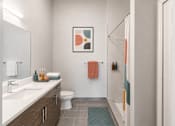 Thumbnail 29 of 58 - A bathroom with a toilet, sink, and shower.