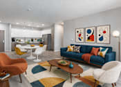 Thumbnail 9 of 58 - A living room with a blue couch and a white coffee table.