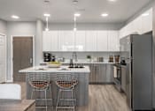 Thumbnail 8 of 58 - A modern kitchen with a white countertop and stainless steel appliances.