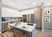 Thumbnail 1 of 58 - A modern kitchen with a white countertop and stainless steel appliances.
