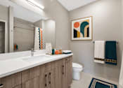 Thumbnail 13 of 58 - A bathroom with a white sink and a toilet.