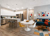 Thumbnail 10 of 58 - A modern kitchen with a dining table and chairs.