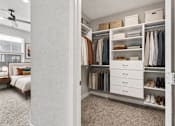 Thumbnail 16 of 39 - A bedroom with a large closet and a bed.