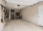Thumbnail 18 of 39 - A room with a white door and a bicycle hanging on the wall.
