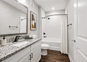 Thumbnail 14 of 39 - A white bathroom with a toilet, sink, and a shower.