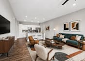 Thumbnail 10 of 39 - A modern living room with a green sofa and wooden furniture.