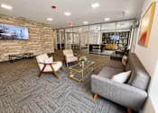 Thumbnail 49 of 64 - A modern living room with a grey carpet and a stone wall.