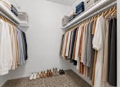 Thumbnail 13 of 87 - A row of clothes hanging on a rack.