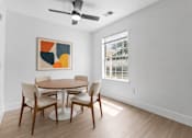 Thumbnail 7 of 87 - A dining room with a table and chairs and a painting on the wall.