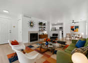 Thumbnail 4 of 87 - A living room with a leopard print couch and a white chair.