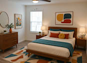 Thumbnail 16 of 20 - A bedroom with a bed, nightstands, and a rug.