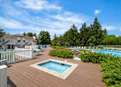 Thumbnail 67 of 87 - Outdoor pool deck with hot tub and seating at Village Club of Farmington Hills Apartments, Farmington Hills, 48331