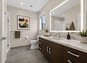 Thumbnail 33 of 58 - A bathroom with a toilet, sink, and mirror.