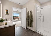 Thumbnail 34 of 58 - A bathroom with a white sink and a glass shower stall.