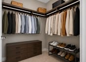 Thumbnail 32 of 58 - A closet with clothes and shoes.