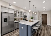 Thumbnail 24 of 58 - A modern kitchen with a large island and stainless steel appliances.