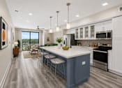Thumbnail 25 of 58 - A modern kitchen with a blue island and white cabinets.