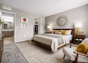 Thumbnail 47 of 87 - Modern bedroom with ensuite bathroom and walk-in closet at Village Club of Farmington Hills Apartments, Farmington Hills