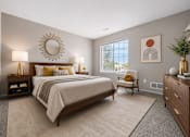Thumbnail 46 of 87 - Modern bedroom with natural light and wood furniture at Village Club of Farmington Hills Apartments, Michigan