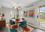 Thumbnail 54 of 87 - Dining room with midcentury modern furniture and pop art at Village Club of Farmington Hills Apartments, Farmington Hills, Michigan