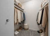 Thumbnail 58 of 87 - Walk-in closet with organized storage shelving at Village Club of Farmington Hills Apartments, Michigan