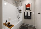 Thumbnail 60 of 87 - Modern bathroom with white subway tile and tub shower combo at Village Club of Farmington Hills Apartments, Michigan, 48331