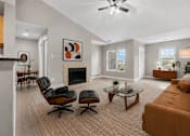 Thumbnail 44 of 87 - Spacious living room with vaulted ceiling and fireplace at Village Club of Farmington Hills Apartments, Farmington Hills, Michigan