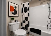 Thumbnail 49 of 87 - Contemporary bathroom with geometric shower curtain and white tile at Village Club of Farmington Hills Apartments, Michigan