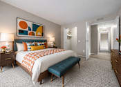 Thumbnail 63 of 87 - Spacious bedroom with teal accents and geometric artwork at Village Club of Farmington Hills Apartments, Farmington Hills, MI