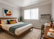 Thumbnail 21 of 26 - A bedroom with a large bed and a painting on the wall.