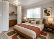 Thumbnail 17 of 26 - A bedroom with a large bed and a wooden nightstand.