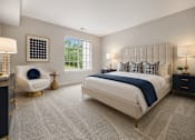 Thumbnail 35 of 87 - Modern bedroom with upholstered headboard and navy accents at Village Club of Farmington Hills Apartments, Michigan, 48331